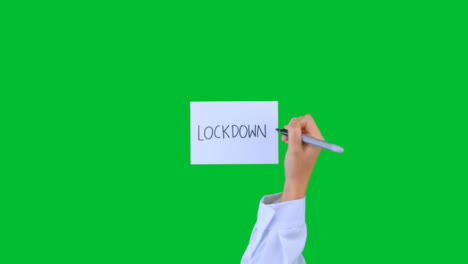 Doctor-Writing-Lockdown-on-Paper-with-Green-Screen